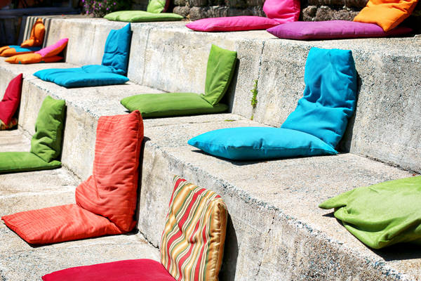 Colorful Seat Cushions Neatly Arranged on Concrete Steps