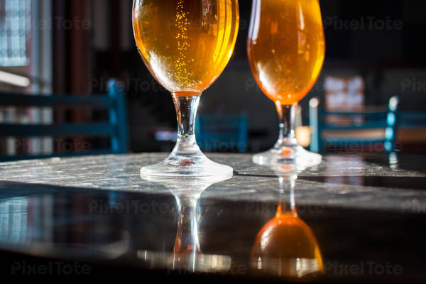 Back-Lit Short Stem Beer Glasses with Bubbles on a Table