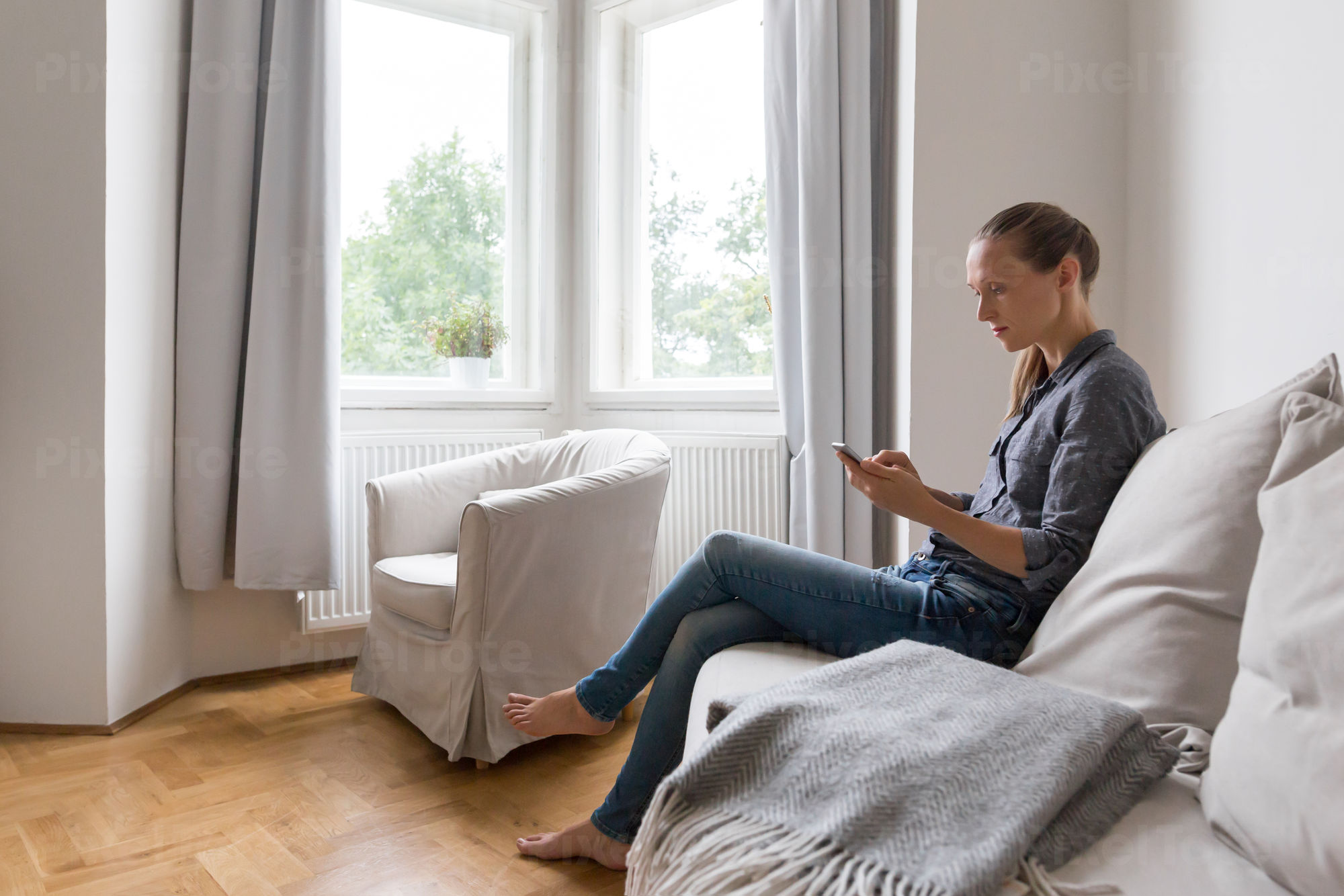 Young Woman Sitting In A Living Stock Photo Pixeltote