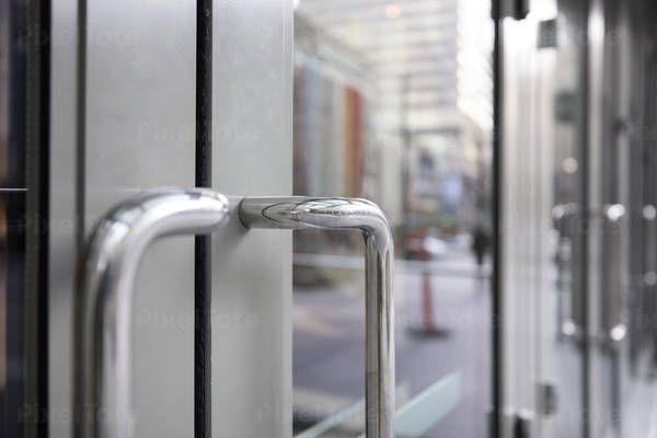 Close-Up View of Metal Door Handles on an Administrative Building