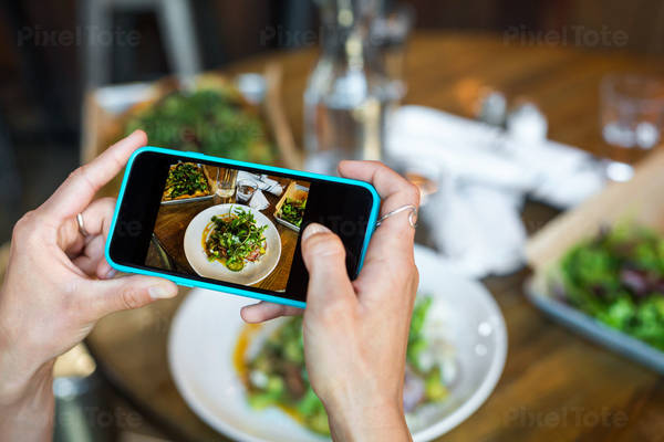 Hands of a Woman Taking Picture of Her Meal with a Picture Phone