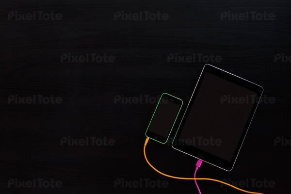 Light Contours of a Cell Phone and a Digital Tablet on a Dark Background