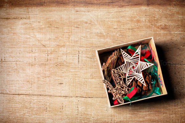 High-Angle View of Tree Ornaments in a Box Placed on a Wooden Table