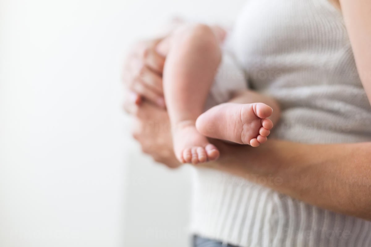 Close-Up of Newborn Baby's Feet Stock Photo - PixelTote