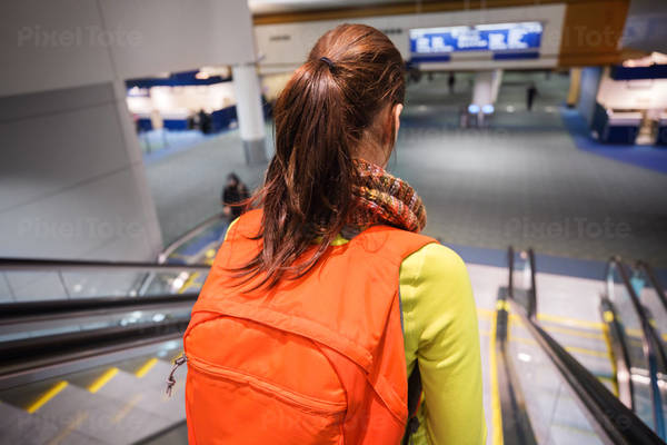 Woman Going down on Escalator at the Airport