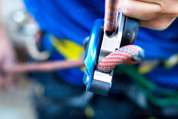 Close-Up of an Assisted Belay Device in Use by a Climber