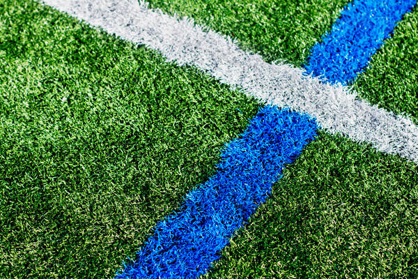 Close-Up View of Turf Lines on a Sports Field in an Urban Area