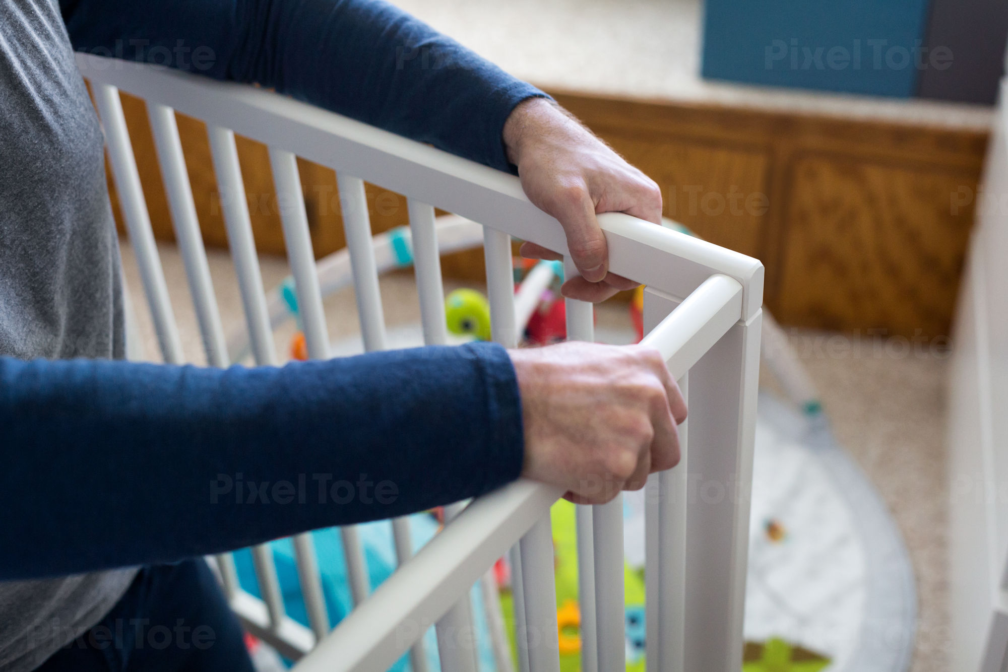 Man Assembling Baby Crib in a Stock Photo PixelTote