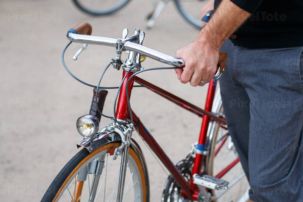 Man Holding Handle Bars of a Vintage Bicycle