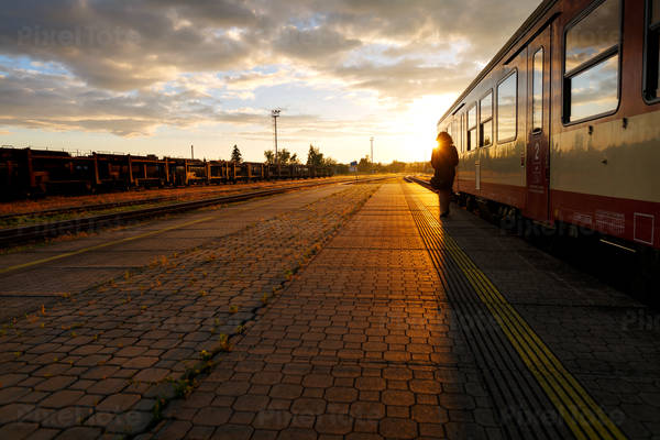 Train Standing by a Train Station Platform During Sunset