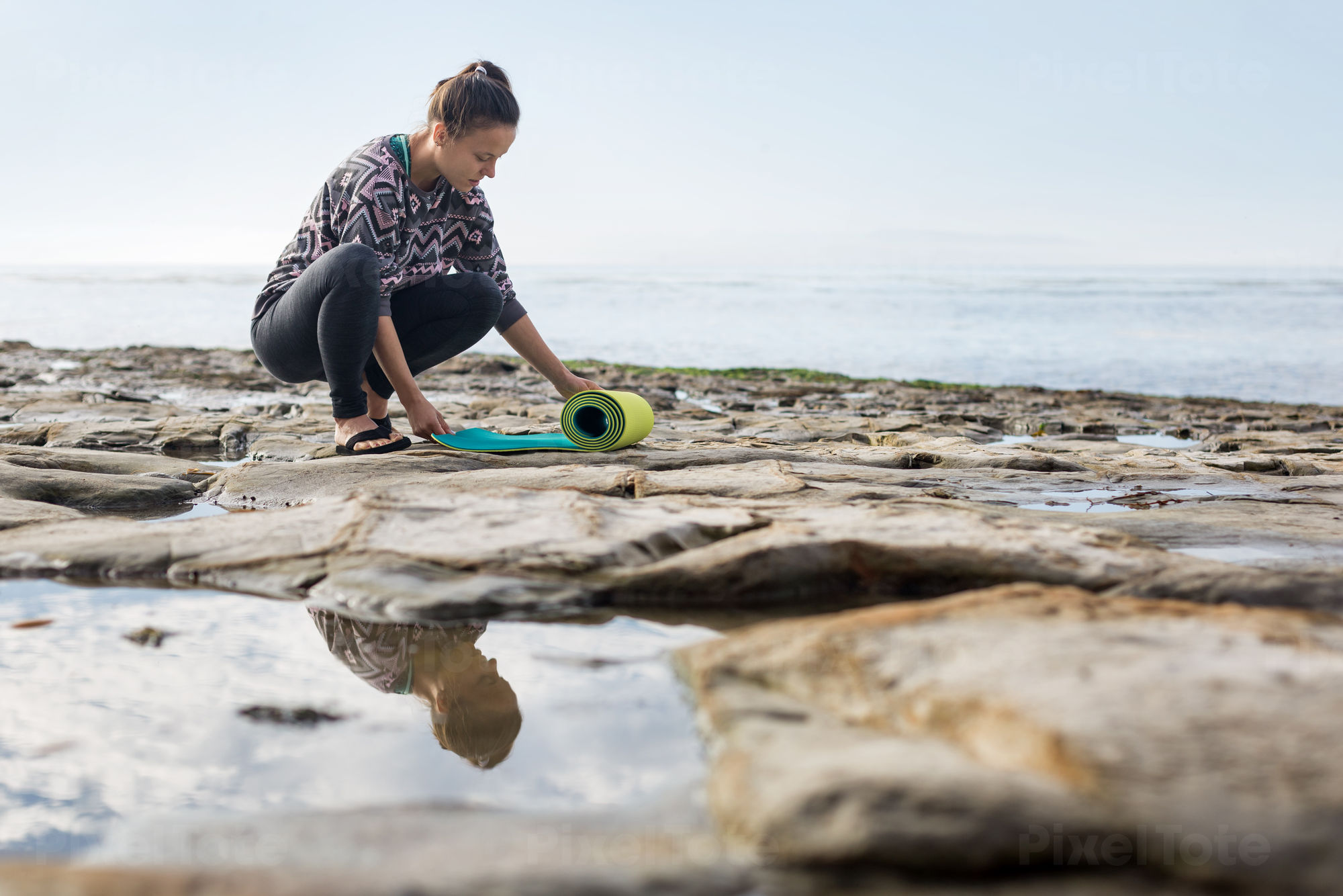 Young Woman Practicing a Yoga Stock Photo - PixelTote