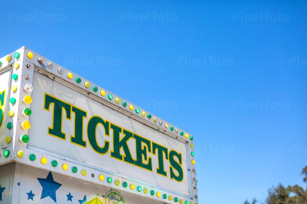 Green and Yellow Sign on a Ticket Booth at a County Fair