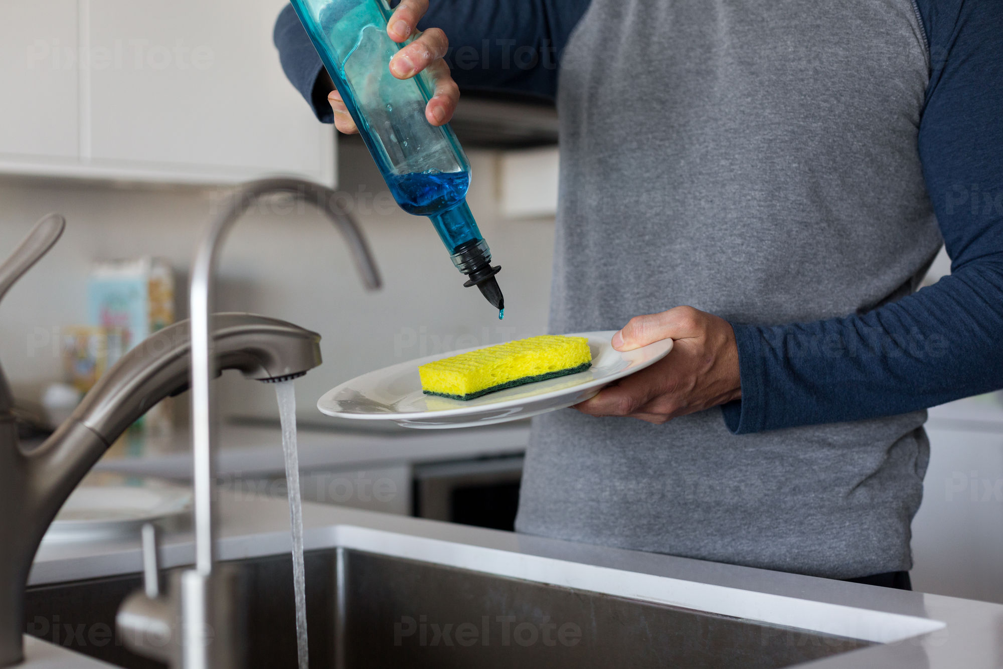 Man Washing Dishes in a Sink Stock Photo - PixelTote