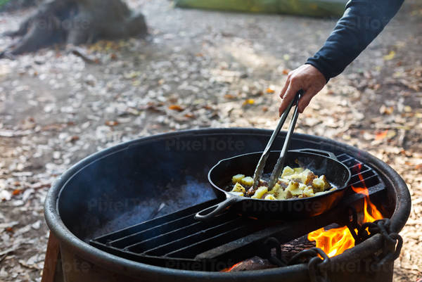 Close-up of a Man Cooking Breakfast on an Outdoor Fire Pit
