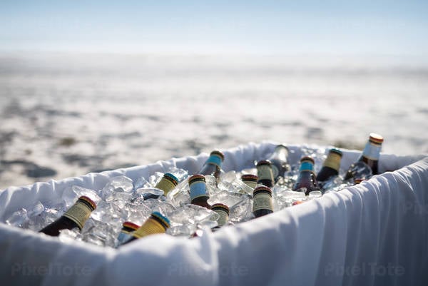 Beer Bottles in a Cooler on the Beach