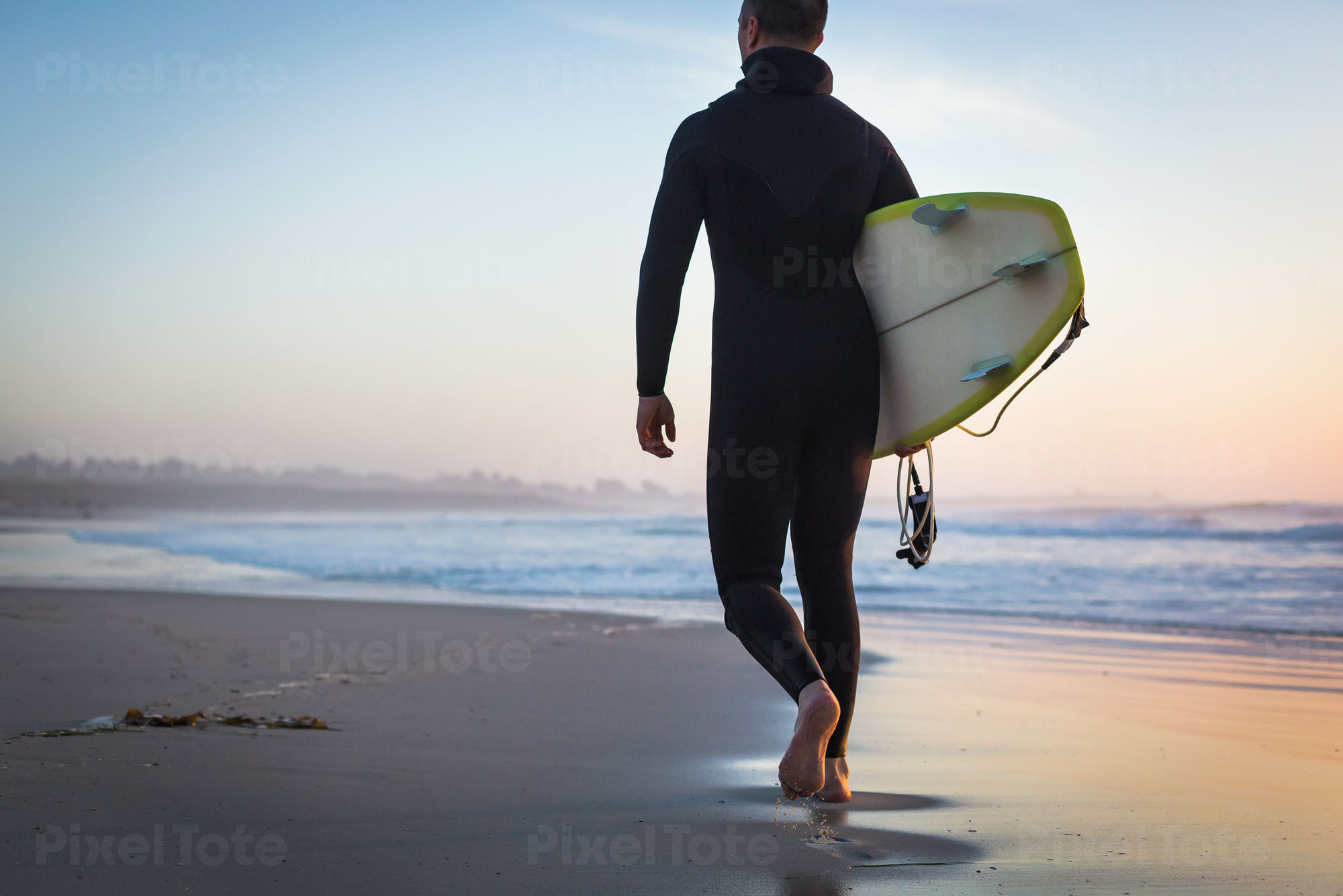 Male Surfer with a Surfboard Stock Photo - PixelTote