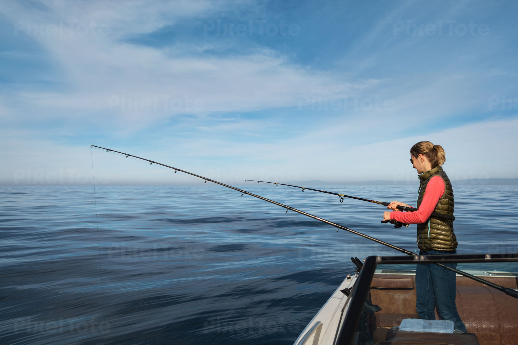 https://cdn.pixeltote.com/marketing/assets/previews/b/6/b629b5e6-1c86-4647-a85f-2daf32b3447f/pv-lg-young-woman-fishing-from-a-boat-on-a-calm-ocean-default-stock-photo.jpg