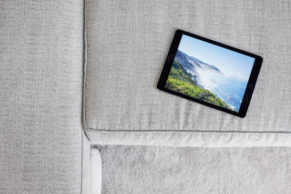 Directly-from-Above View of a Digital Tablet on a White Sofa