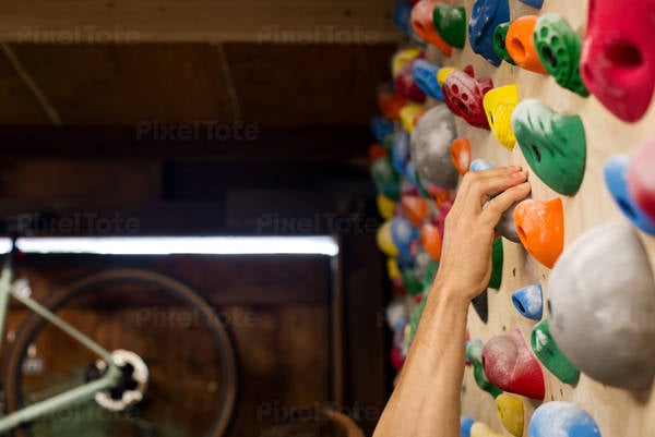 Man's Hand Gripping a Hold on a Practice Wall at Home