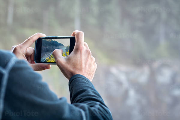 Man Taking Picture with a Cell Phone