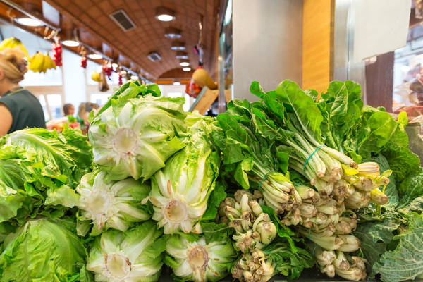 Fresh Leafy Vegetables Stacked at an Indoor Farmers Market
