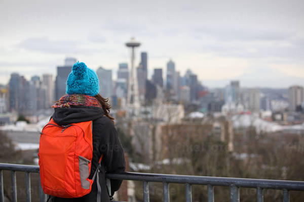 Girl with a Backpack Looking at Seattle Cityscape Before the Dusk