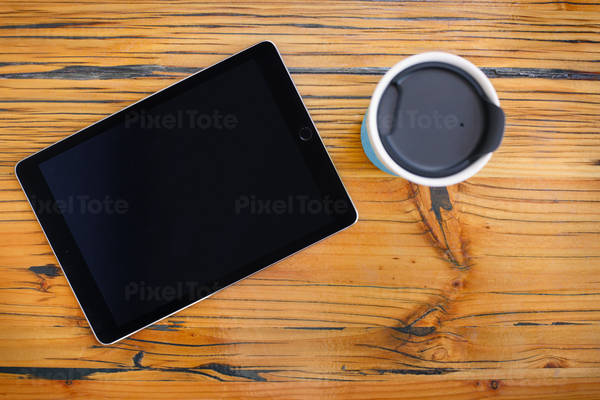Directly from Above View of a Digital Tablet and a Coffee Mug on a Wooden Table