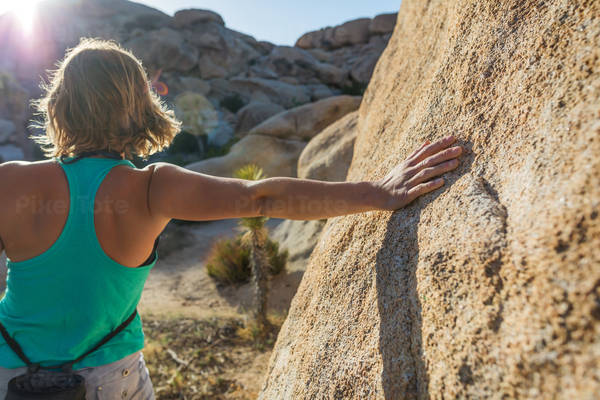 Young Woman Stretching Prior an Outdoor Bouldering Session