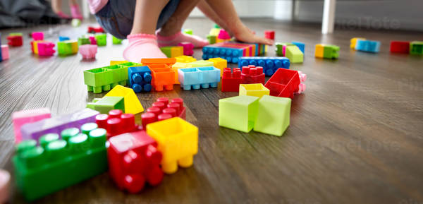Low Angle View of a Little Girl Playing with Plastic Blocks