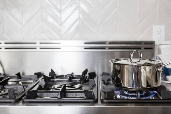 Cooking a Meal in a Stainless Steel Pot on a Gas Stove