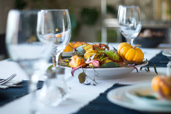 Thanksgiving Table Setting with Pumpkins and Leaves