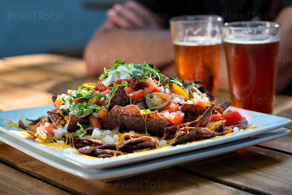 Nachos with Cheese and Beer on a Table