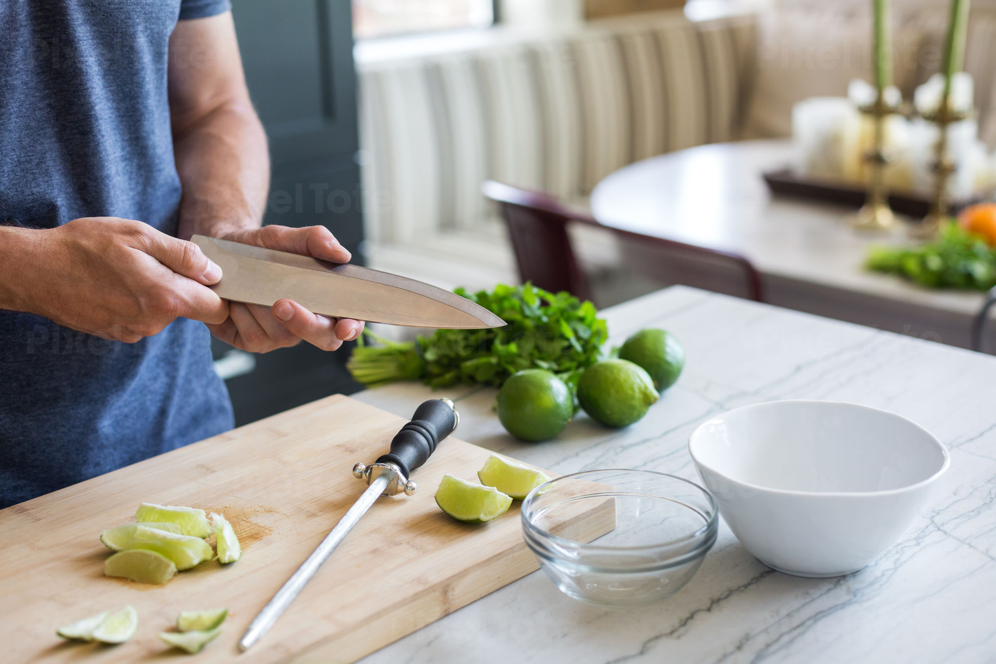 Male Cook Checking Sharpness Stock Photo - PixelTote