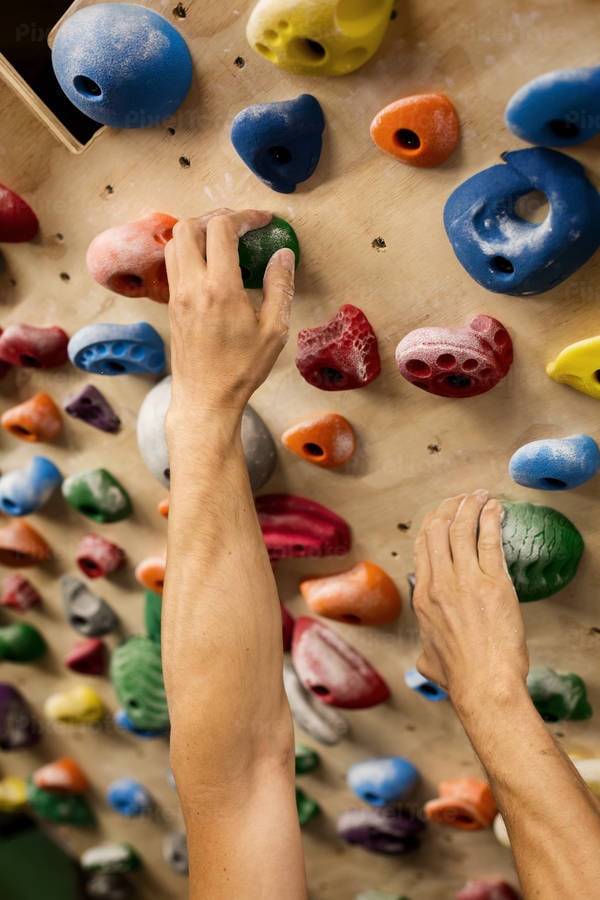 Man's Hands Holding Holds on a Practice Wall at Home