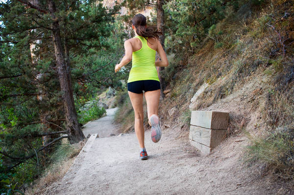 Rear View of a Woman Jogging on a Trail