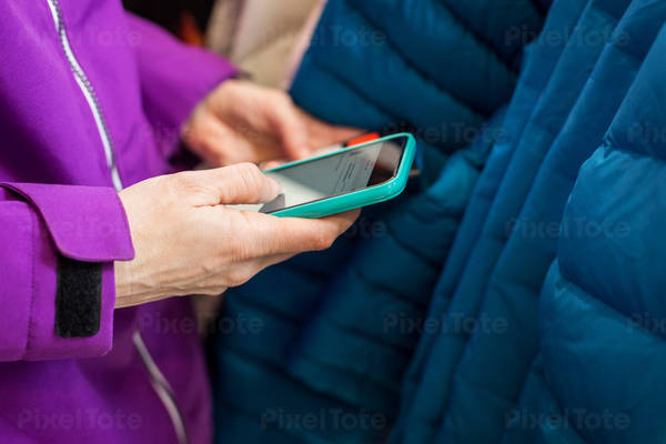 Woman Using a Cell Phone to Compare a Product Price