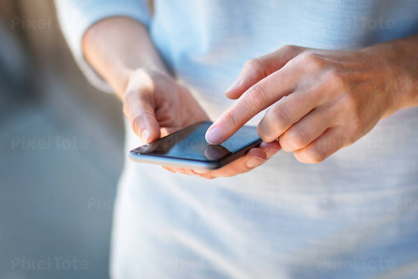 Detailed Low Angle View of a Woman Typing on a Cell Phone