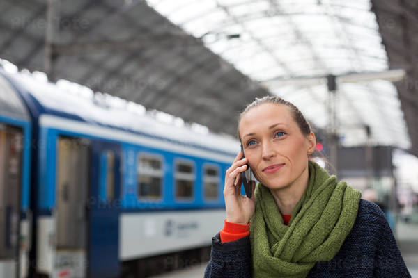 Woman Making a Phone Call in a Train Station