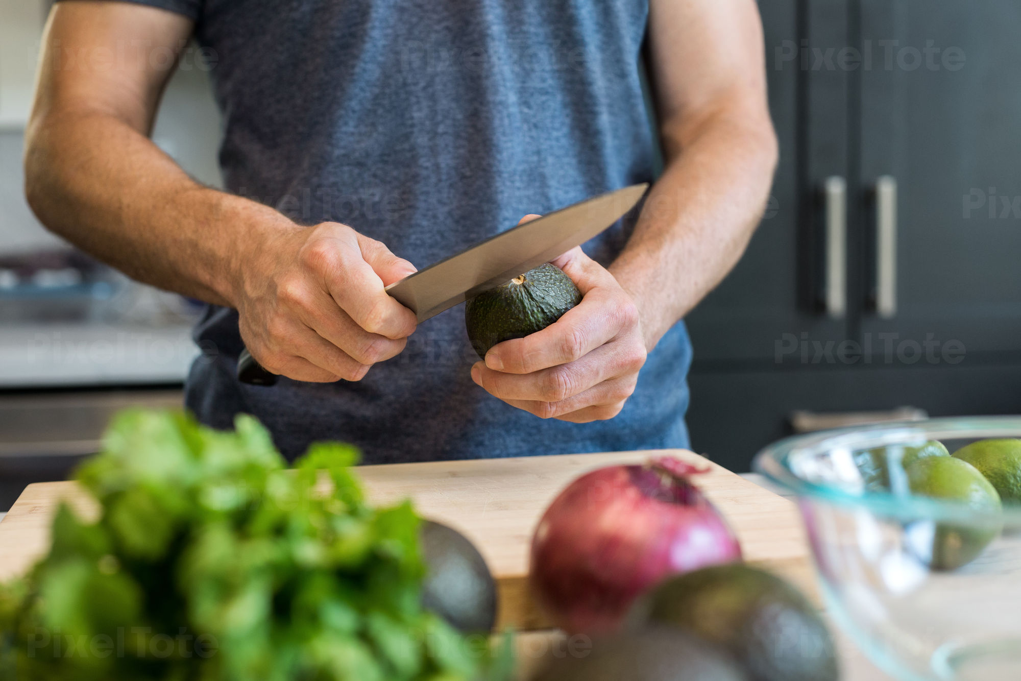 https://cdn.pixeltote.com/marketing/assets/previews/f/d/fd0451c0-3655-48be-bb41-15d541b4c613/pv-lg-close-up-of-a-man-cutting-avocado-in-a-domestic-kitchen-default-stock-photo.jpg