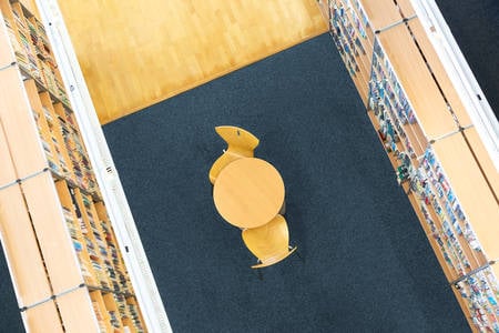 From-Above View of a Table with Chairs and Books on Shelves in a Library