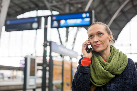 Woman Making a Phone Call in a Railroad Station