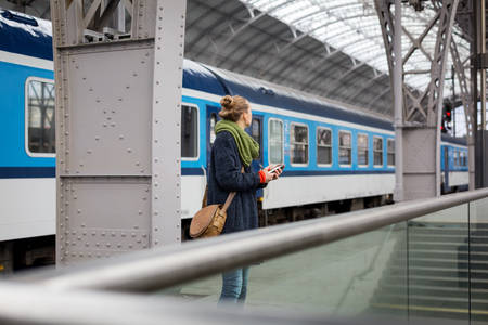 Woman Looking Around at a Train Station Platform