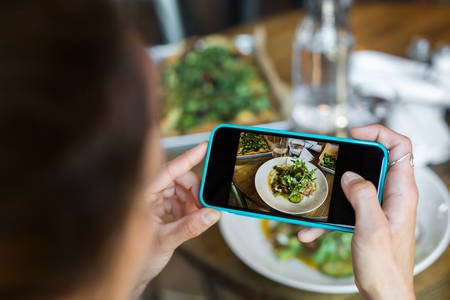 Close-Up of a Woman Taking Picture of Her Meal with a Smartphone