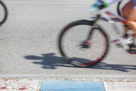 Blurred Road Bikes on an Asphalt Road During a Cycling Race