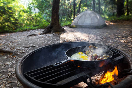 An Iron Skillet With Breakfast Eggs And, Cooking Potatoes Fire Pit