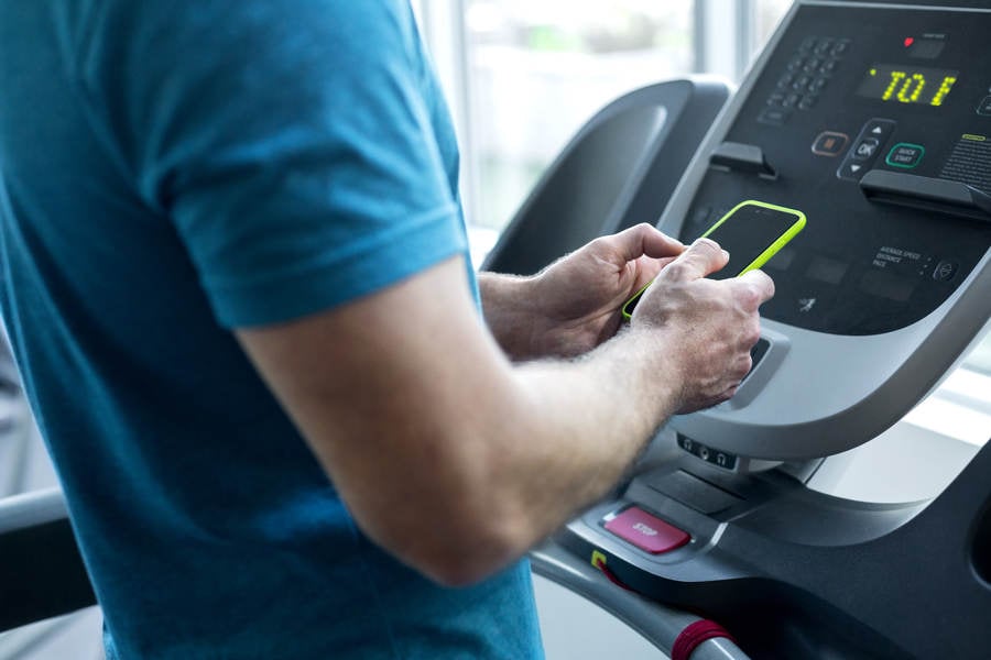 Man Standing on a Treadmill and Stock Photo - PixelTote