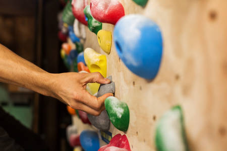 Man's Hands Holding Hold on a Practice Wall at Home