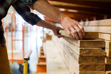 Man Loading Lumber in a Home Improvement Store 