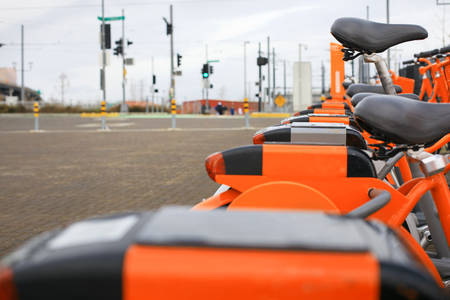 Low-Angle View of a Row of Orange City Bikes