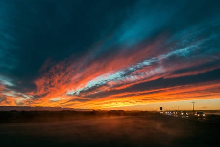 Dramatic Sunset with Colorful Sky and a Road Dust